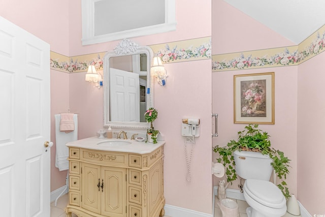 bathroom featuring tile patterned floors, toilet, and vanity