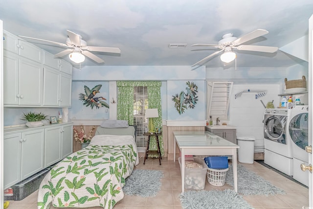 bedroom featuring light tile patterned flooring, sink, washer and clothes dryer, and ceiling fan