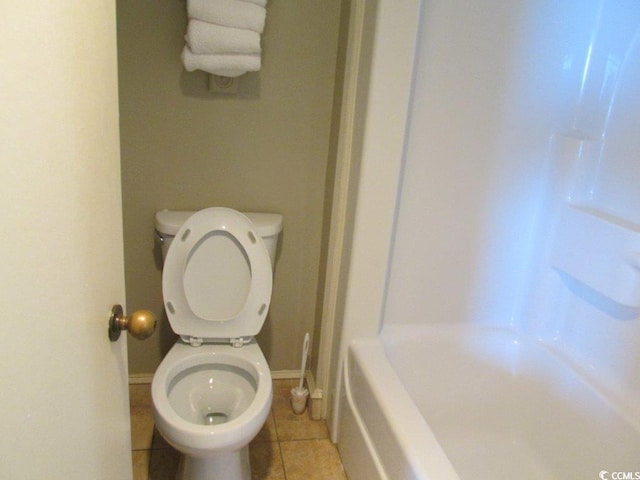 bathroom with toilet, shower / bathing tub combination, and tile patterned floors