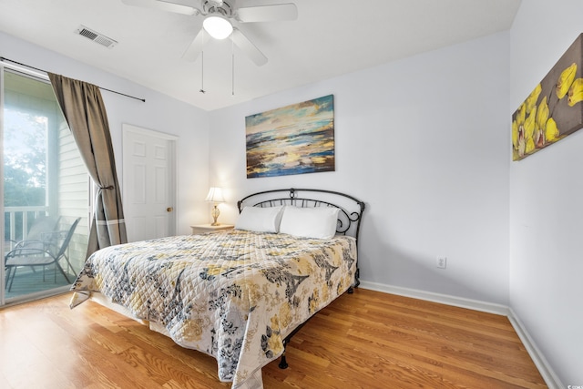 bedroom featuring visible vents, baseboards, wood finished floors, a ceiling fan, and access to outside