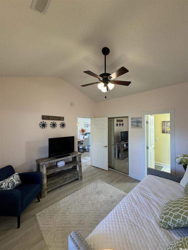 bedroom with visible vents, a ceiling fan, wood finished floors, a closet, and vaulted ceiling