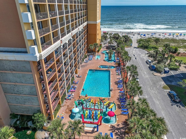 drone / aerial view with a beach view and a water view