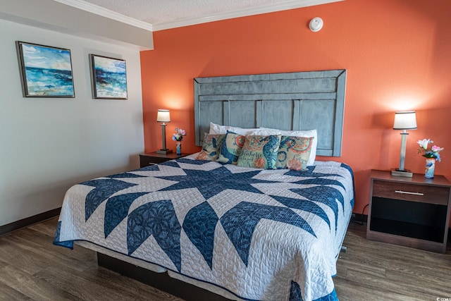 bedroom featuring crown molding, wood finished floors, baseboards, and a textured ceiling