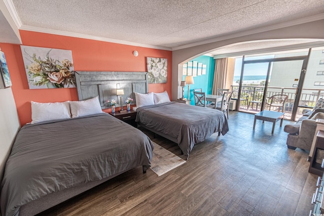 bedroom with access to exterior, ornamental molding, wood finished floors, arched walkways, and a textured ceiling