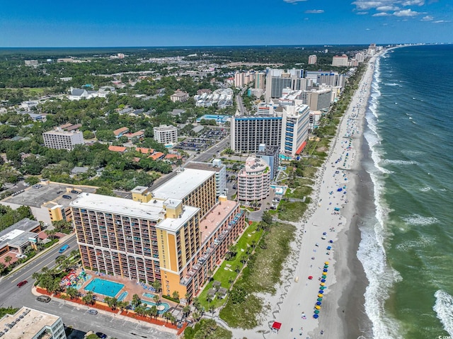 drone / aerial view with a water view, a city view, and a view of the beach