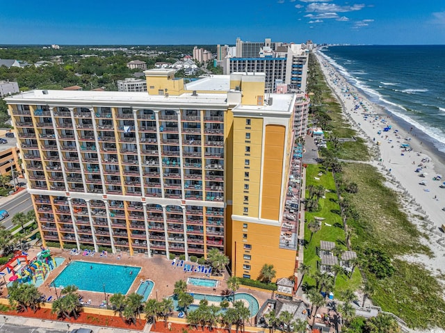 birds eye view of property with a water view, a view of city, and a view of the beach