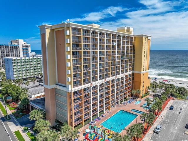 view of property featuring a beach view and a water view