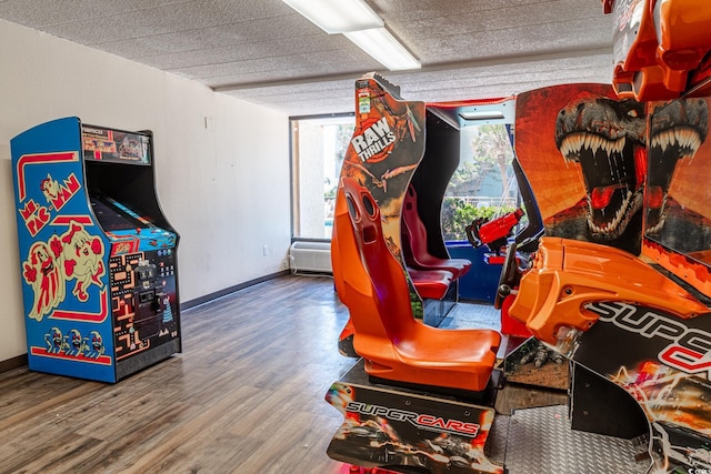 playroom with a wealth of natural light, baseboards, and wood finished floors