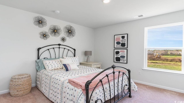 bedroom featuring light colored carpet