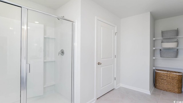 bathroom with tile patterned flooring and a shower with shower door