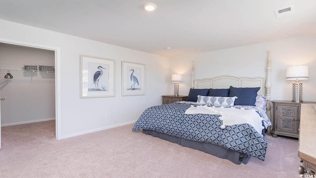 bedroom with light colored carpet and a closet