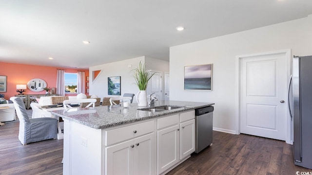 kitchen featuring an island with sink, white cabinets, stainless steel appliances, dark hardwood / wood-style floors, and sink