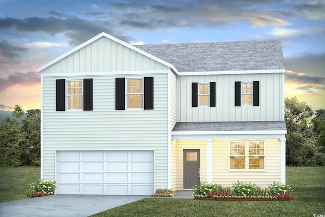 view of front of house with a lawn and a garage