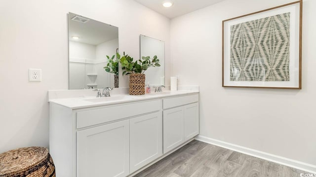 bathroom featuring vanity and hardwood / wood-style flooring