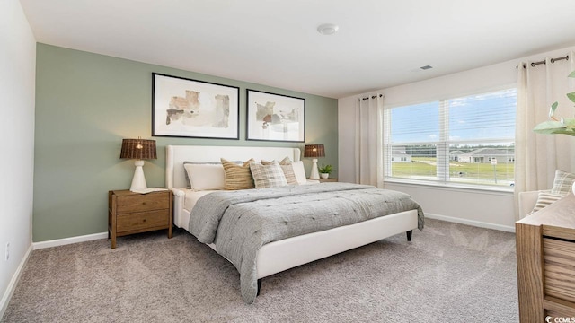 bedroom with light colored carpet