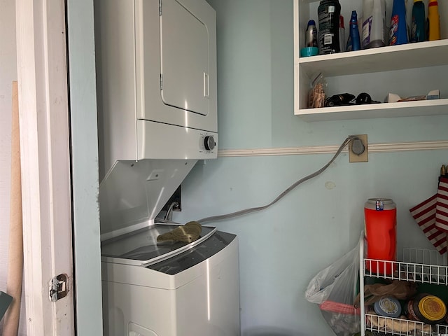 laundry room with stacked washer / dryer