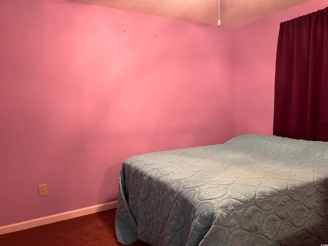 bedroom with carpet and a textured ceiling