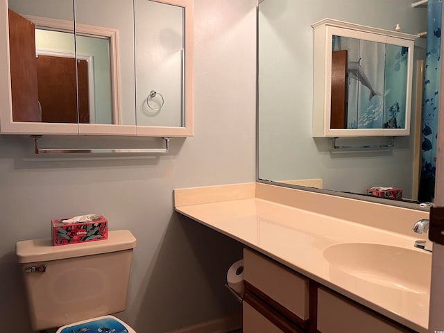 bathroom featuring vanity and toilet