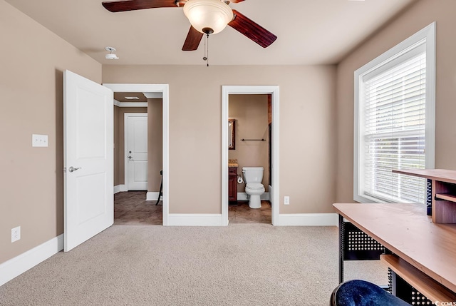 unfurnished office featuring light colored carpet and ceiling fan