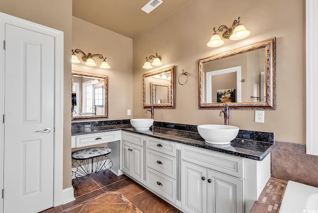 bathroom with tile patterned flooring and vanity