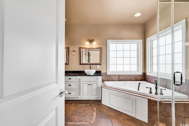 bathroom with vanity and independent shower and bath