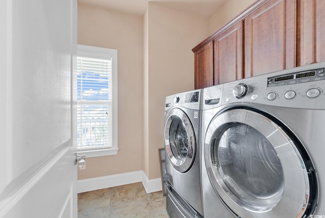 laundry room with cabinets and washing machine and dryer