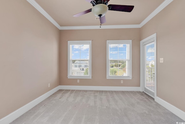 empty room featuring light carpet, ceiling fan, and crown molding