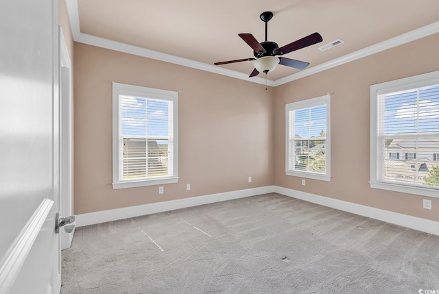 carpeted spare room with crown molding and ceiling fan