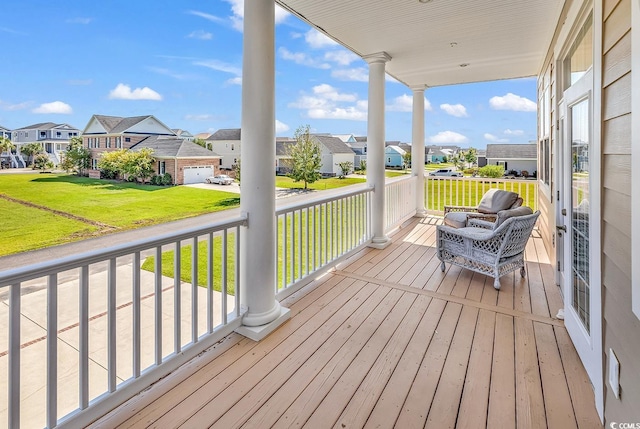 wooden deck with a lawn and a garage