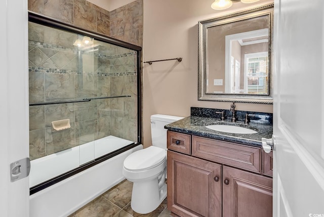 full bathroom with tile patterned floors, vanity, toilet, and combined bath / shower with glass door