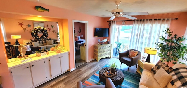 living room with wood-type flooring and ceiling fan