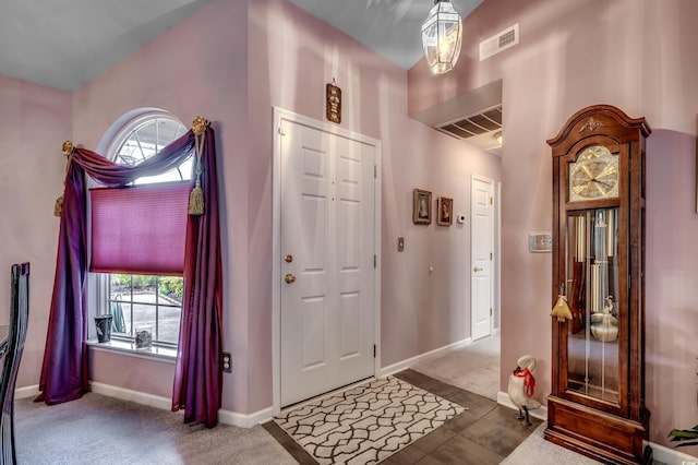 foyer entrance featuring carpet floors