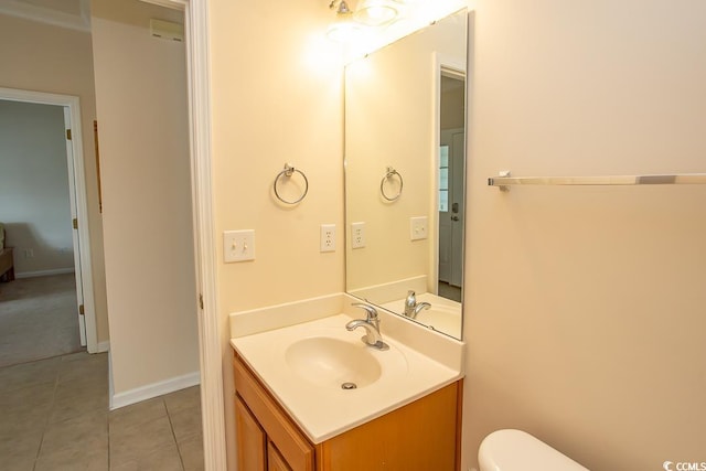 bathroom with vanity, toilet, and tile patterned floors