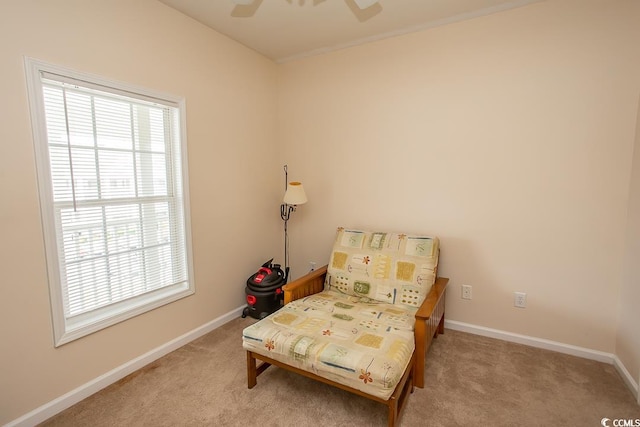 living area featuring ceiling fan and light carpet