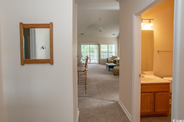 hallway with sink and light tile patterned flooring