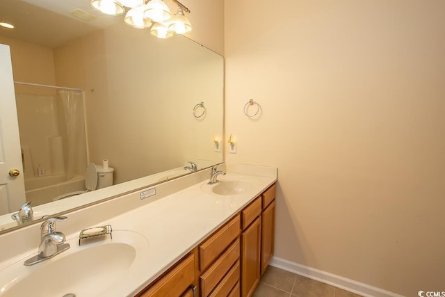 full bathroom featuring vanity, toilet, shower / bath combo with shower curtain, and tile patterned flooring