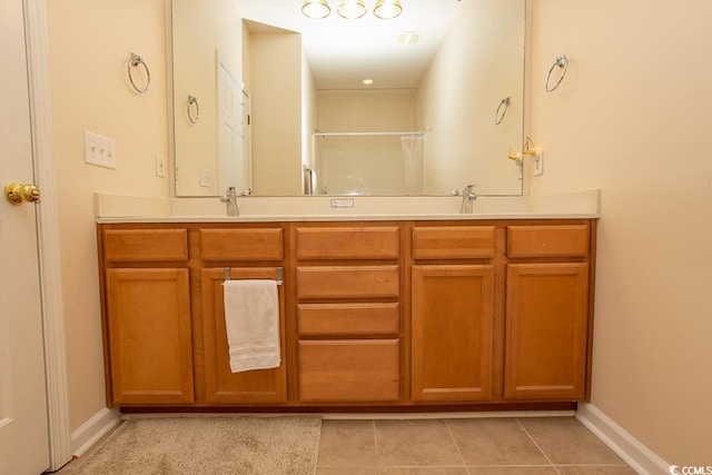 bathroom with vanity, a shower, and tile patterned flooring