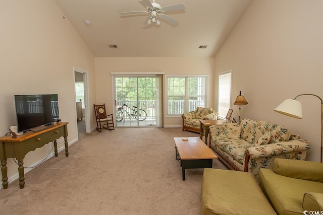 living room featuring high vaulted ceiling, ceiling fan, and light carpet