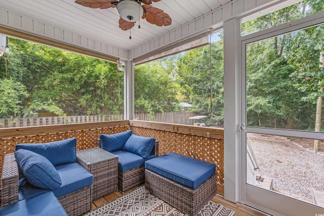 sunroom / solarium with ceiling fan and wooden ceiling