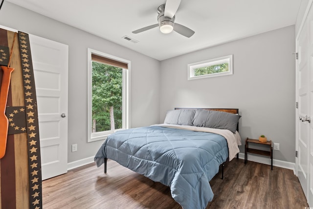 bedroom with ceiling fan and dark hardwood / wood-style floors