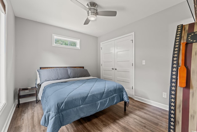 bedroom with a closet, ceiling fan, and dark hardwood / wood-style floors