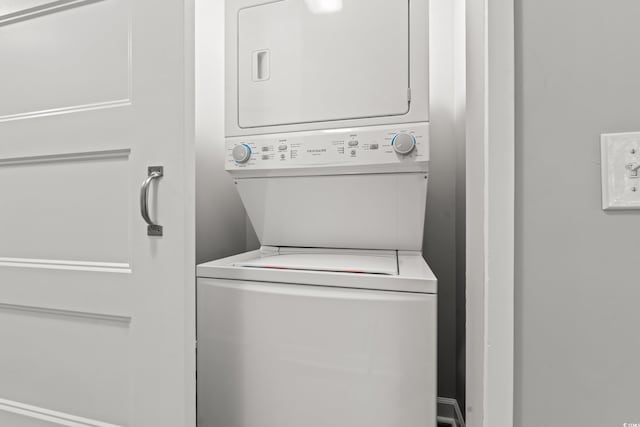 washroom with stacked washer and dryer