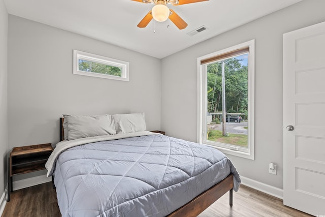 bedroom with ceiling fan and hardwood / wood-style flooring