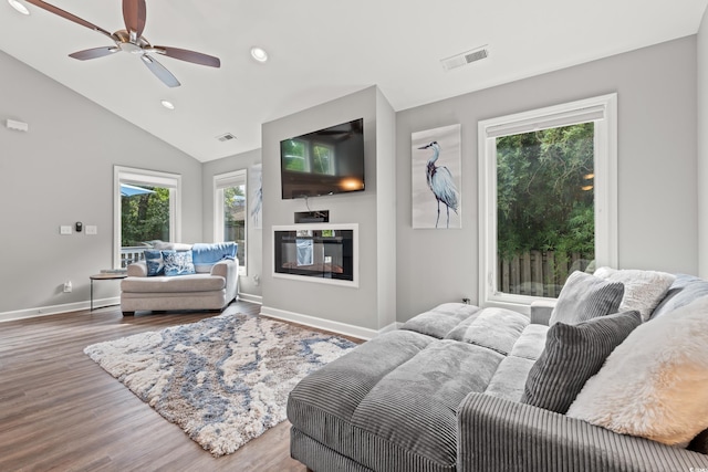 living room featuring lofted ceiling, ceiling fan, and light wood-type flooring