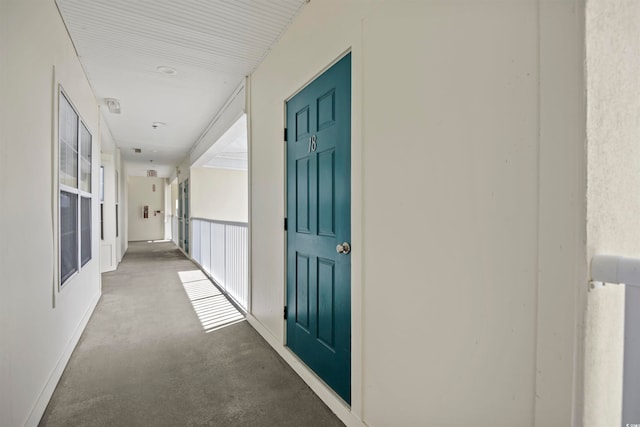 hallway with carpet floors