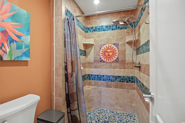 bathroom featuring toilet and curtained shower