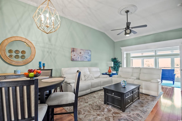 living room featuring hardwood / wood-style flooring, ceiling fan with notable chandelier, ornamental molding, and lofted ceiling