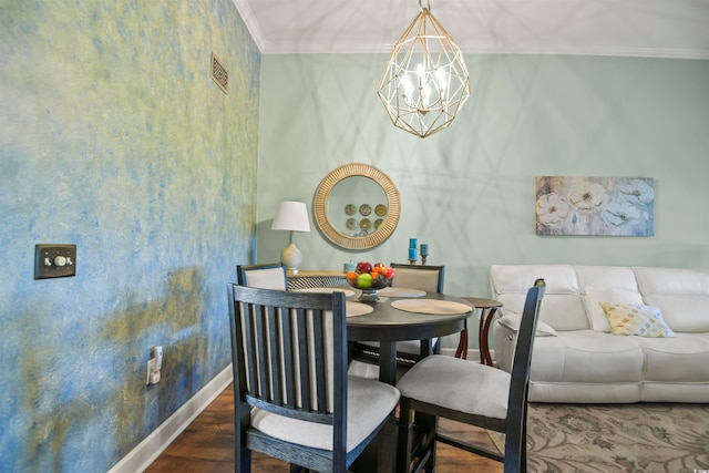 dining room with an inviting chandelier, ornamental molding, and dark wood-type flooring