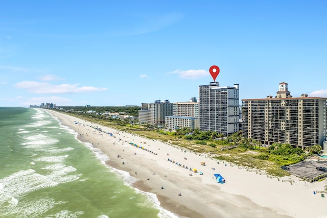 birds eye view of property featuring a water view and a beach view