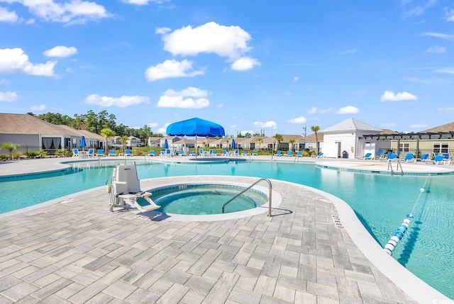 view of swimming pool featuring a community hot tub and a patio